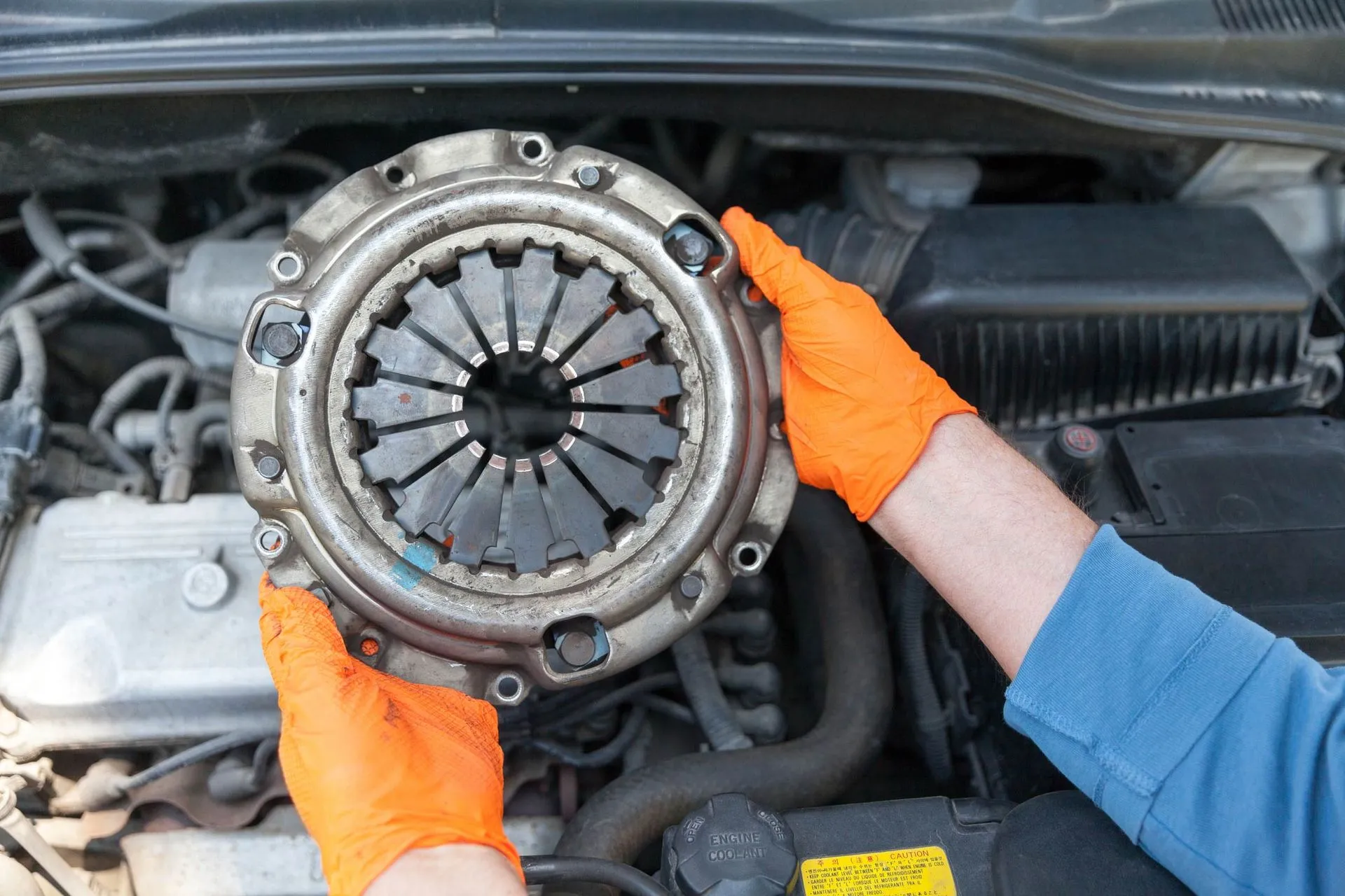 Mechanic inspecting an automatic car’s transmission to explain Does Automatic Transmission Cars Have Clutch?