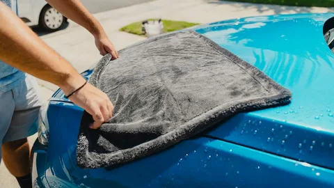 Wiping WD-40 off car paint with a microfiber cloth before rewaxing
